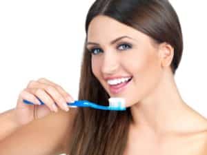 woman about to brush her teeth